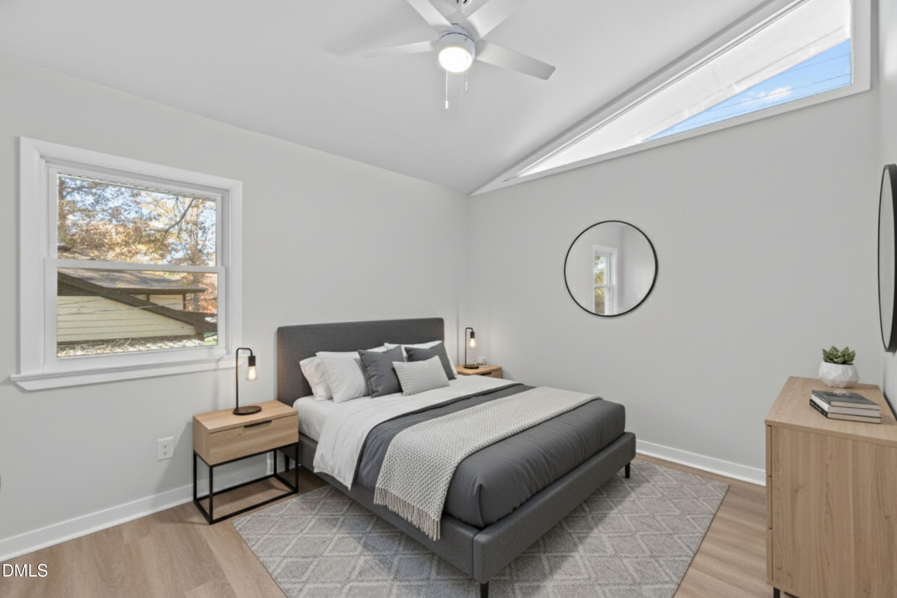 1124 Hardimont Road Raleigh, NC 27609 - Photo 16 of 34 a bedroom with a bed and a chandelier