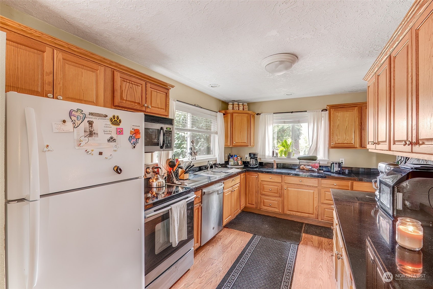 2320 West Castleman Street Longview, WA 98632 - Photo 11 of 36 a kitchen with stainless steel appliances a refrigerator sink and cabinets