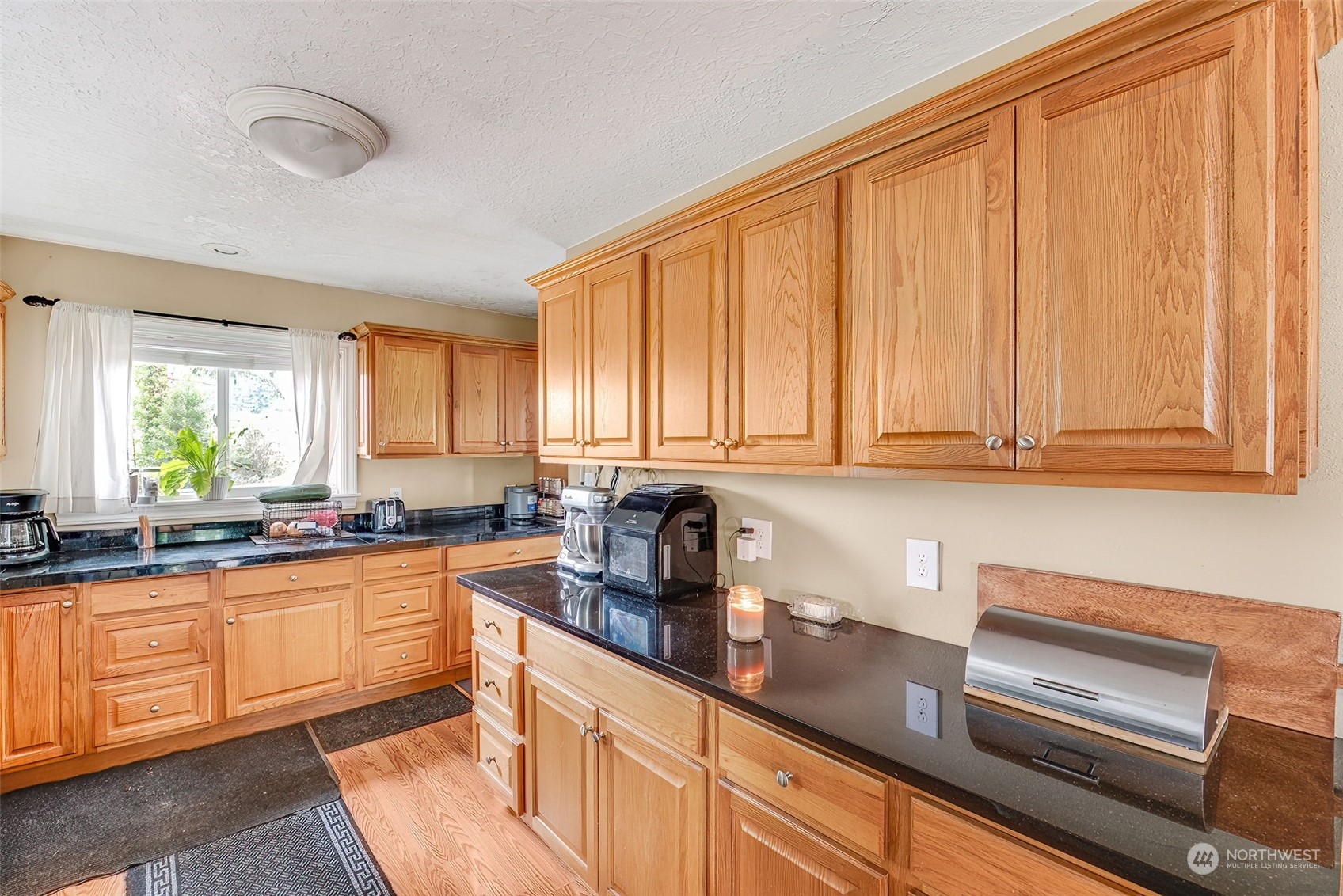 2320 West Castleman Street Longview, WA 98632 - Photo 12 of 36 a kitchen with granite countertop stainless steel appliances sink stove and cabinets