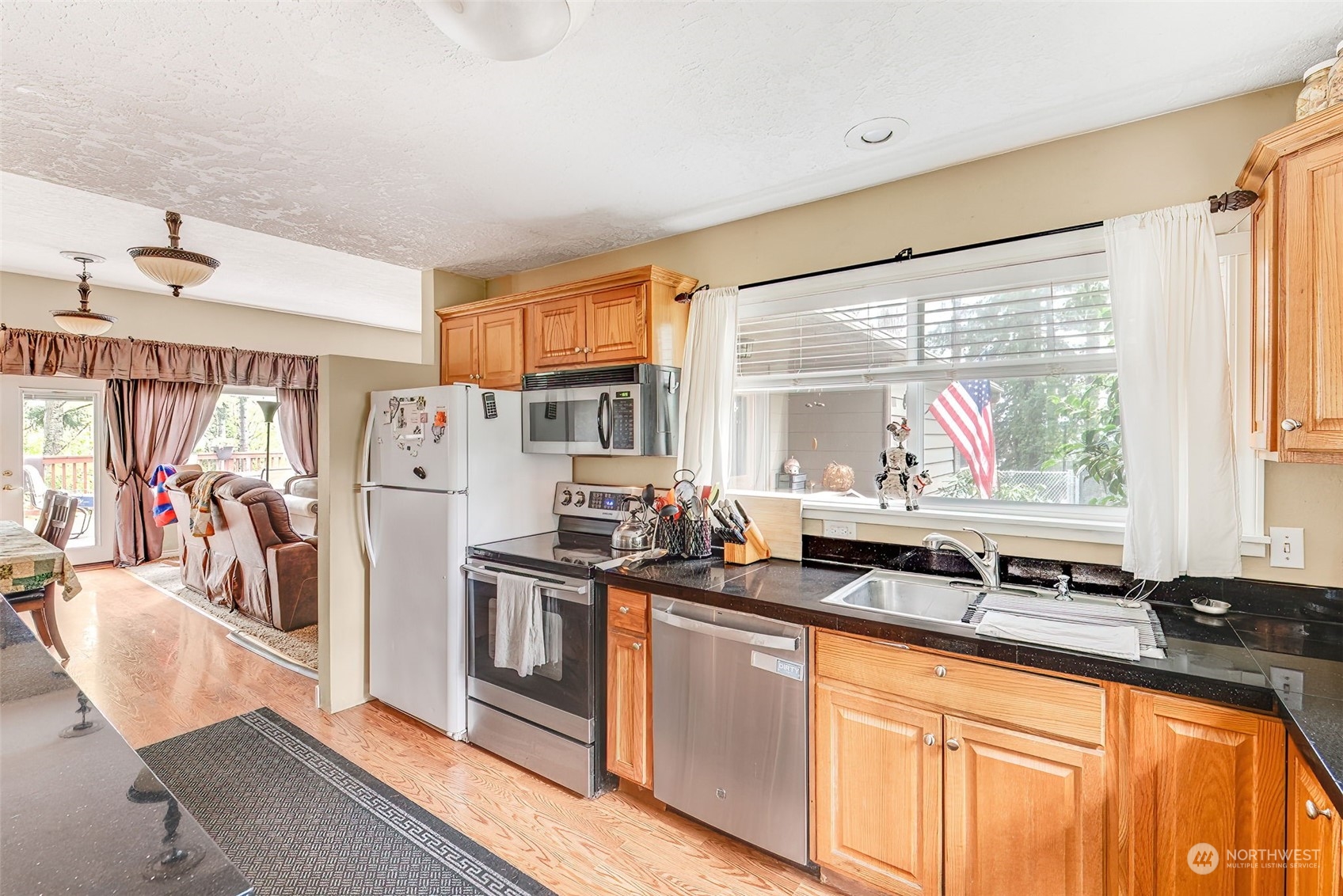 2320 West Castleman Street Longview, WA 98632 - Photo 14 of 36 a view of a kitchen with stainless steel appliances granite countertop a sink and a refrigerator