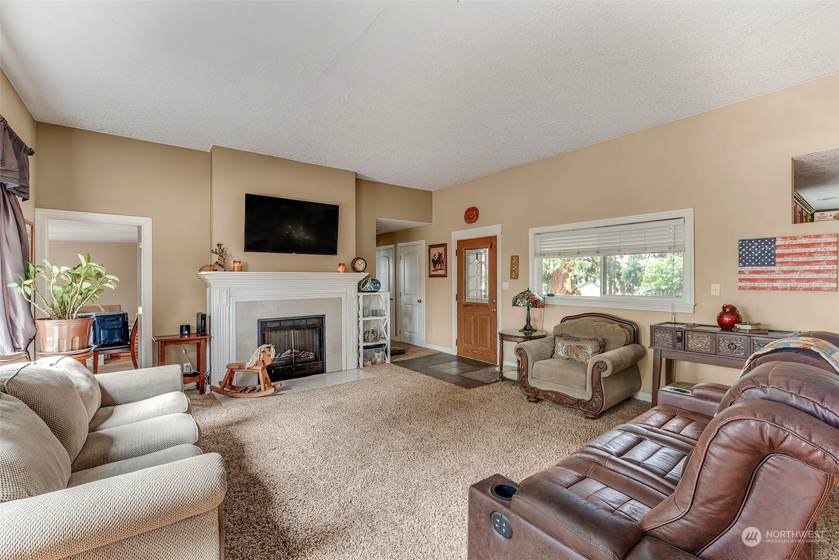 2320 West Castleman Street Longview, WA 98632 - Photo 7 of 36 a living room with furniture a fireplace and a flat screen tv