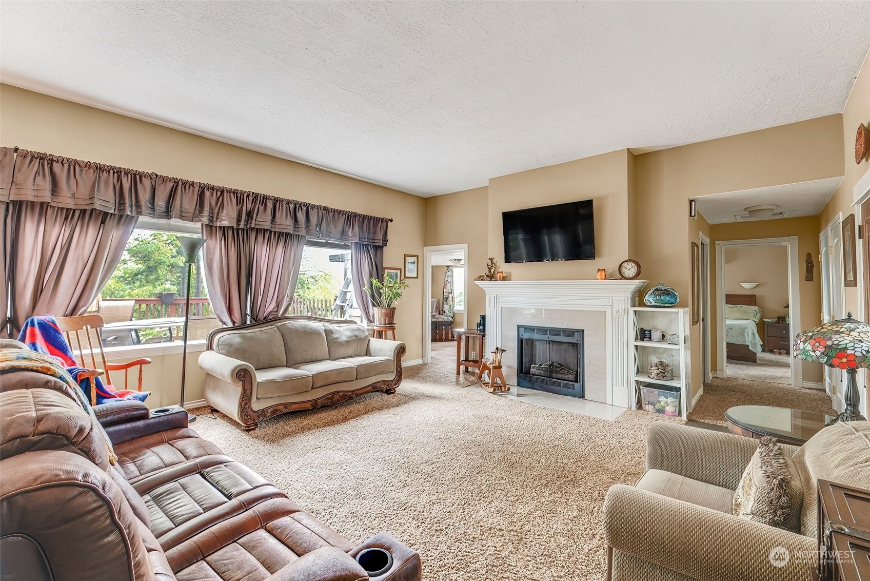 2320 West Castleman Street Longview, WA 98632 - Photo 8 of 36 a living room with furniture a flat screen tv and a fireplace