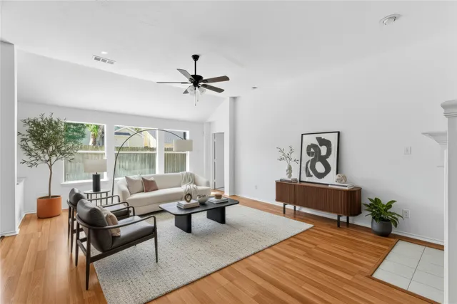 an empty room with a window and wooden floor
