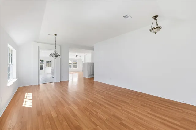 a view of a room with wooden floor and windows