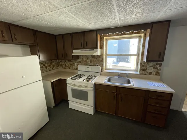 a bathroom with a tub a sink and mirror