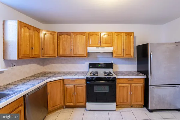 a kitchen with a stove sink and refrigerator