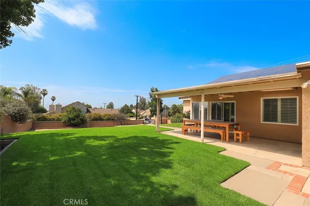 a view of a house with a backyard porch and sitting area