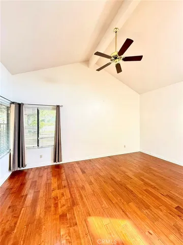 a view of a room with wooden floor and a window