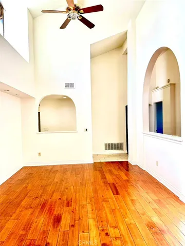 an empty room with a empty space and windows