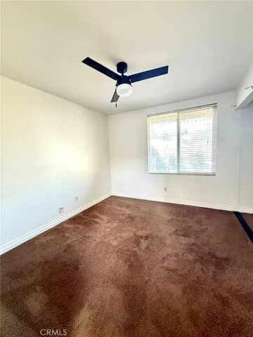 a view of a big room with wooden floor and windows
