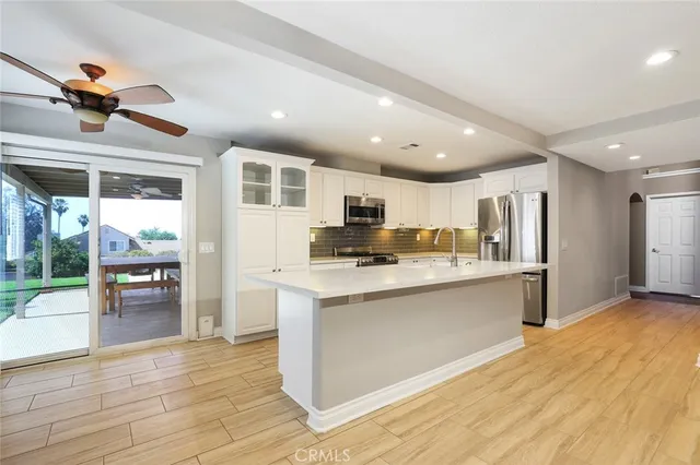 a kitchen with stainless steel appliances granite countertop a refrigerator and a stove top oven