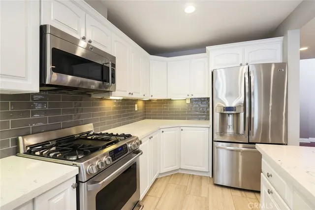 a kitchen with a stove microwave and sink