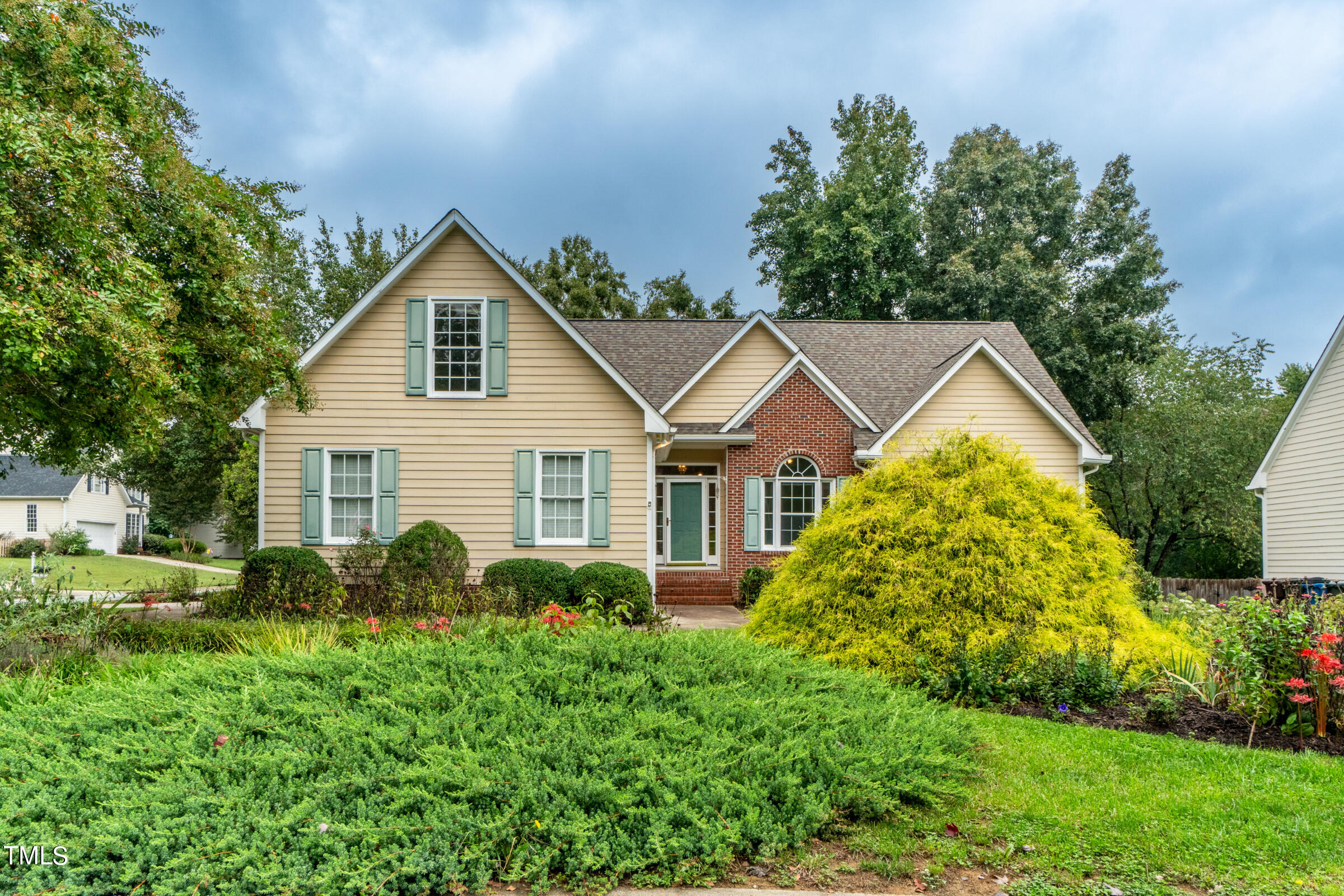a view of a house with garden and plants