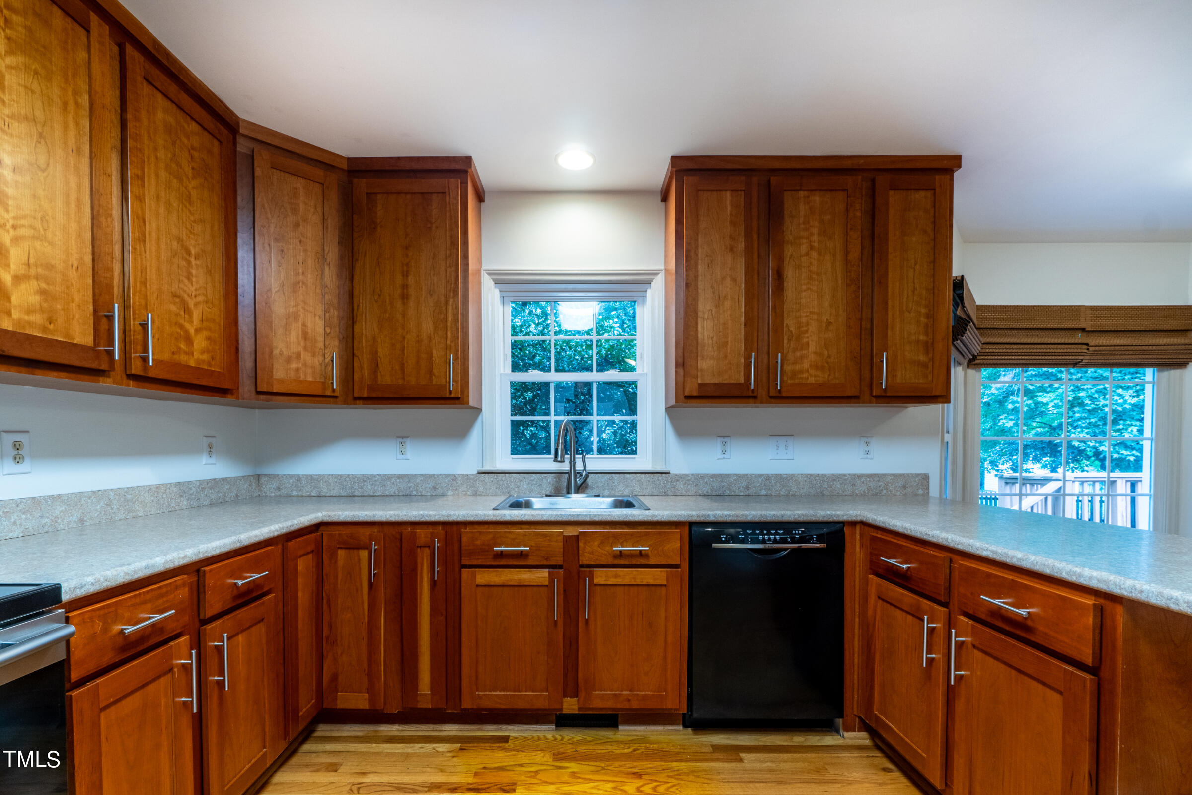 2 Summer Ridge Durham, NC 27712 - Photo 11 of 29 a kitchen with granite countertop wooden cabinets a sink and dishwasher