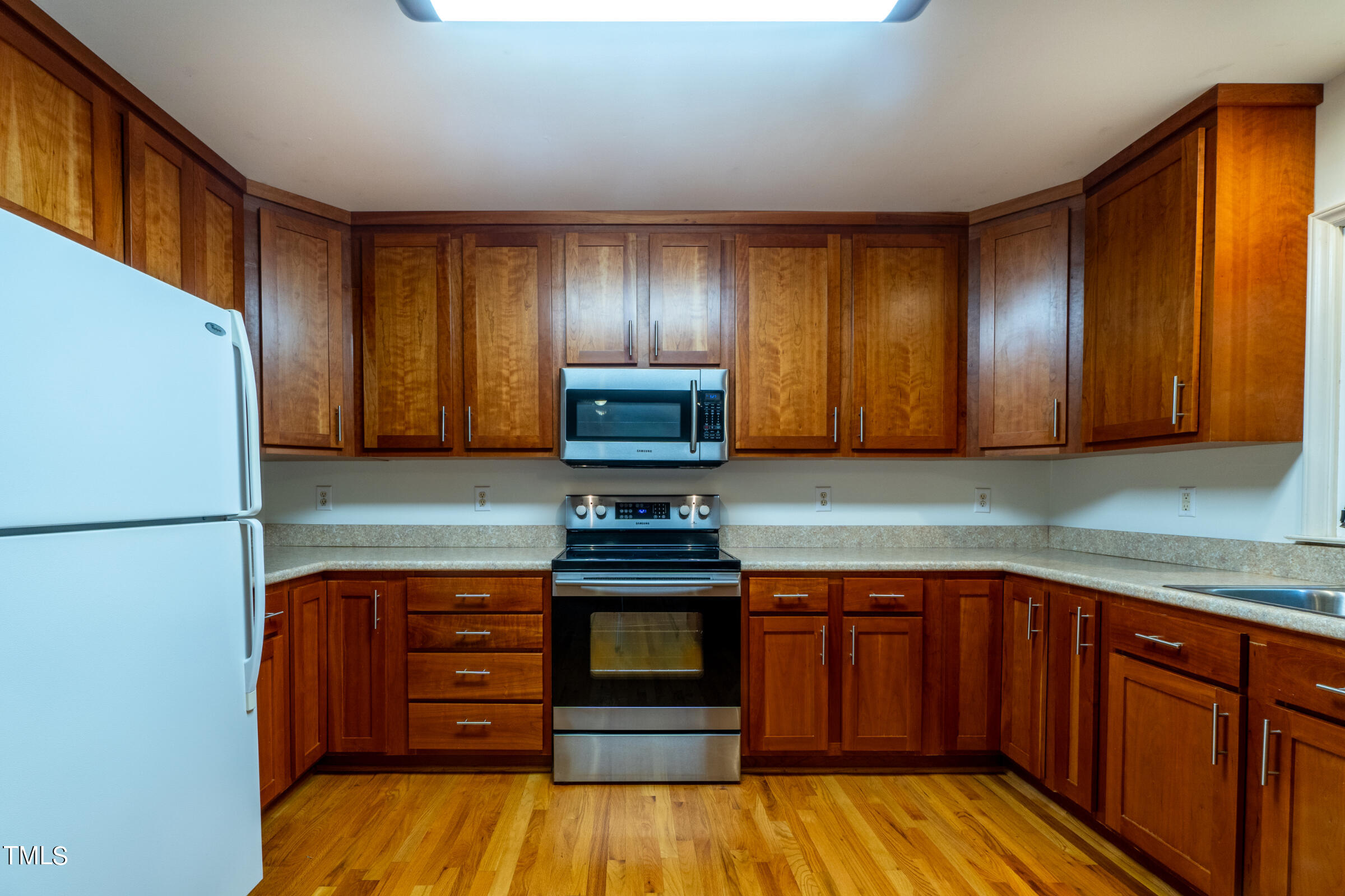 2 Summer Ridge Durham, NC 27712 - Photo 10 of 29 a kitchen with kitchen island granite countertop wooden cabinets and a refrigerator
