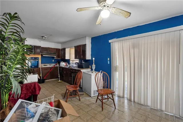 a living room with furniture a chandelier and a window