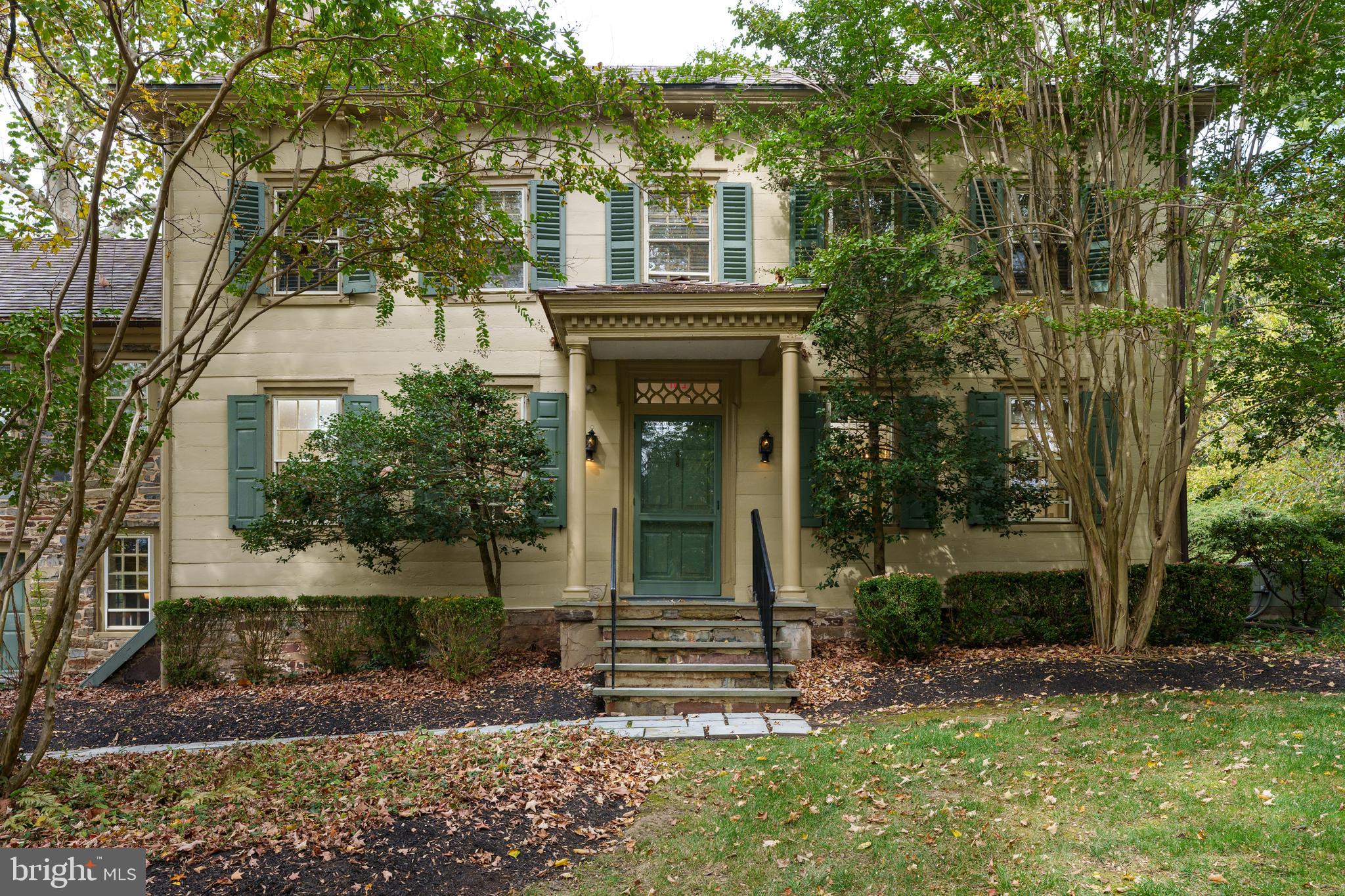 Mature crape myrtles layer the handsome exterior.