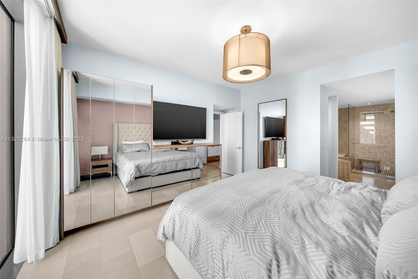 88 Southwest 7th Street, Unit 1212 Miami, FL 33130 - Photo 11 of 45 a bedroom with bed and flat screen tv