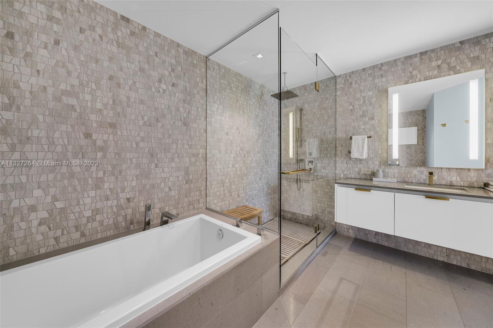 88 Southwest 7th Street, Unit 1212 Miami, FL 33130 - Photo 14 of 45 a bathroom with a bathtub and a sink