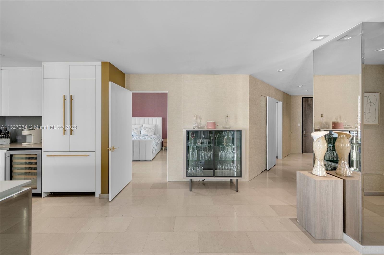 88 Southwest 7th Street, Unit 1212 Miami, FL 33130 - Photo 2 of 45 a view of a kitchen with refrigerator and white cabinets