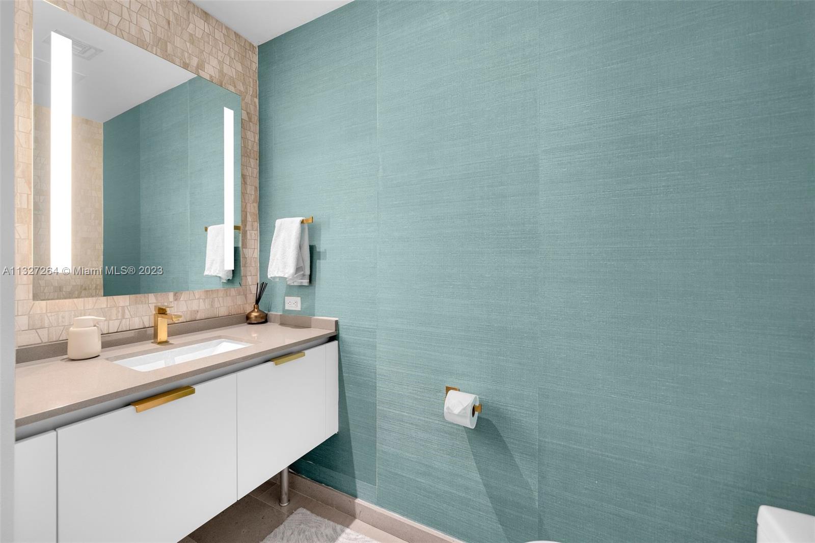 88 Southwest 7th Street, Unit 1212 Miami, FL 33130 - Photo 26 of 45 a bathroom with a granite countertop sink and a mirror