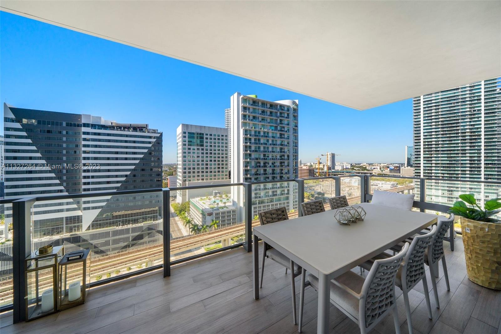 88 Southwest 7th Street, Unit 1212 Miami, FL 33130 - Photo 28 of 45 a view of a dining room with furniture window and wooden floor