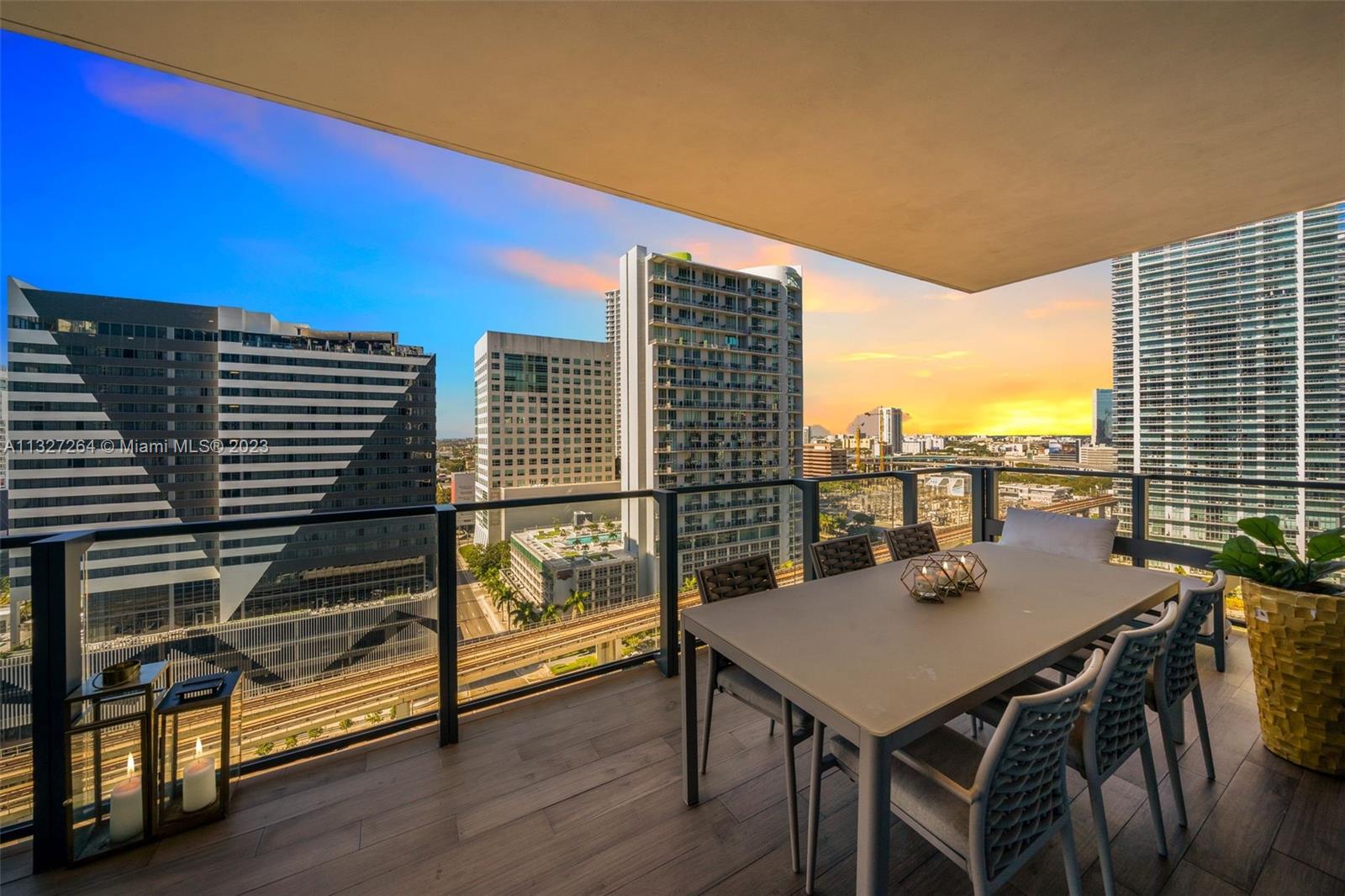 88 Southwest 7th Street, Unit 1212 Miami, FL 33130 - Photo 29 of 45 a view of a balcony with a table and chairs