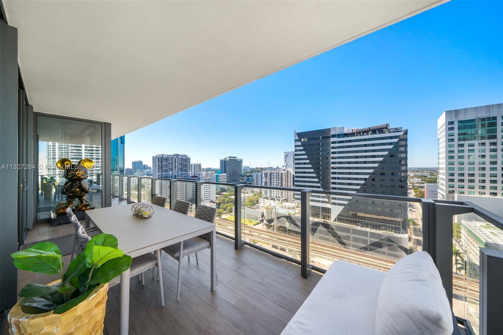 88 Southwest 7th Street, Unit 1212 Miami, FL 33130 - Photo 32 of 45 a view of a dining room with furniture window and wooden floor