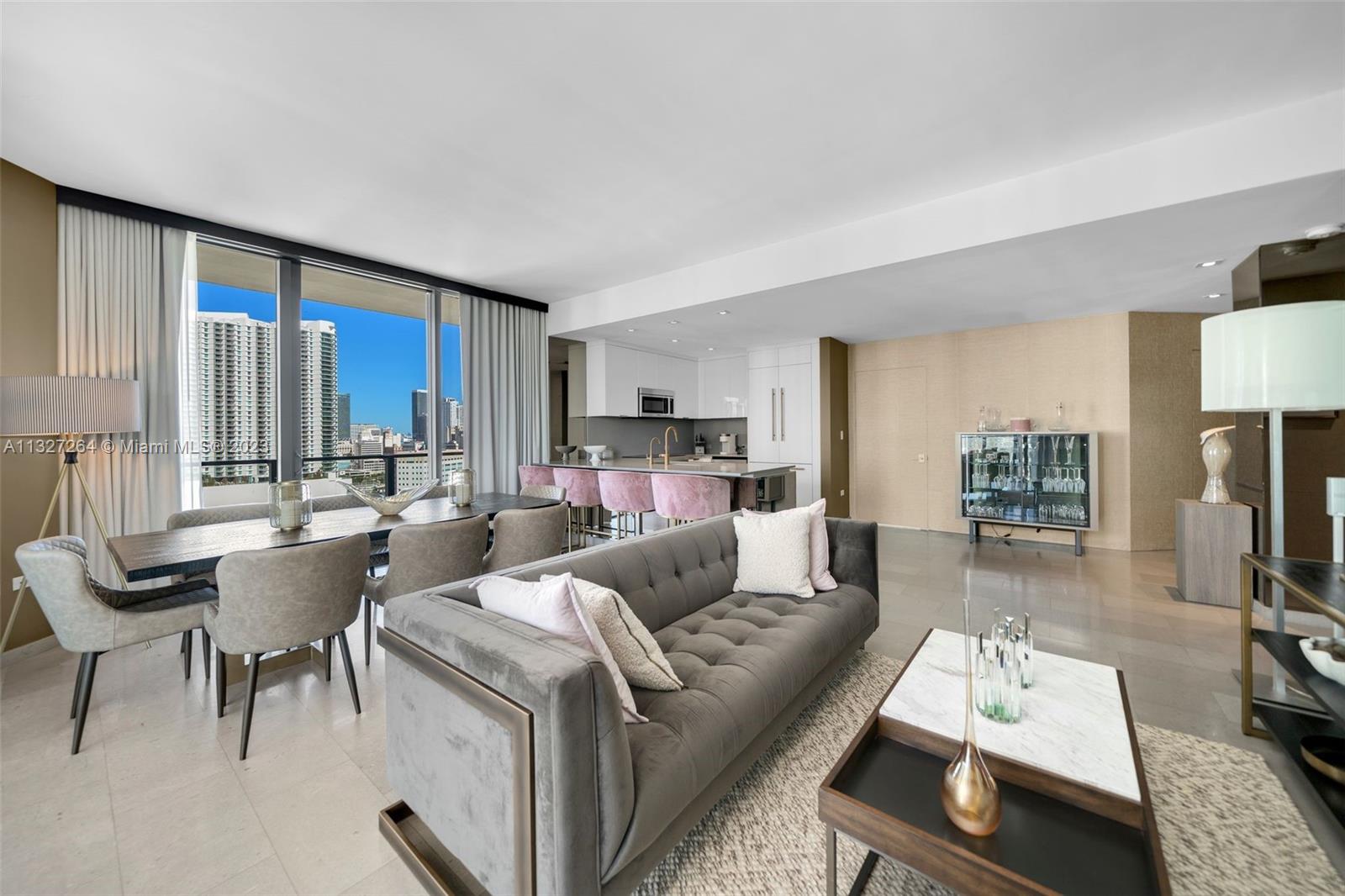 88 Southwest 7th Street, Unit 1212 Miami, FL 33130 - Photo 5 of 45 a living room with furniture and a flat screen tv