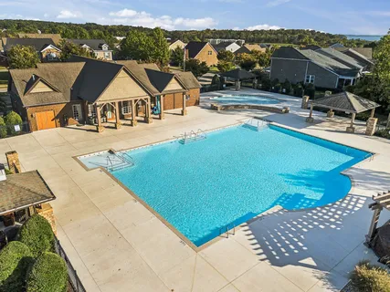 a view of a patio with swimming pool and sitting area