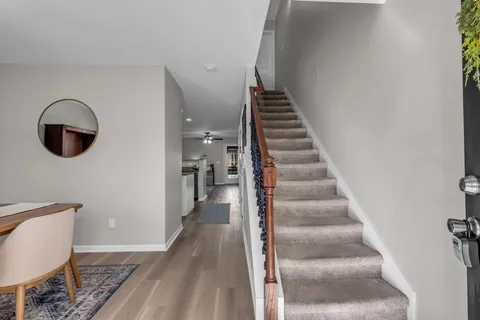 a view of a hallway with wooden floor and entryway