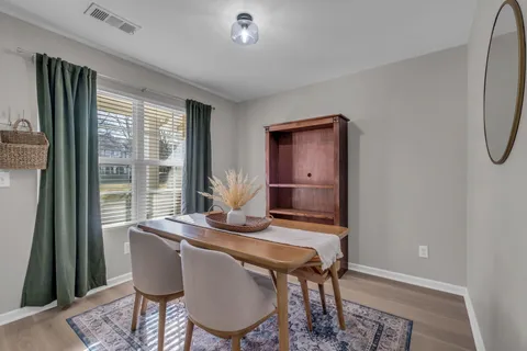 a dining room with furniture and window