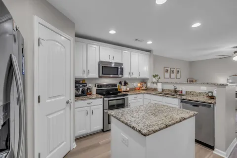 a kitchen with a sink stove microwave and refrigerator