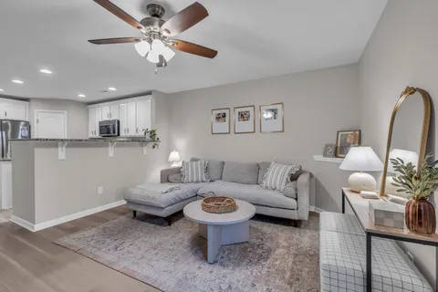 a living room with furniture and a chandelier