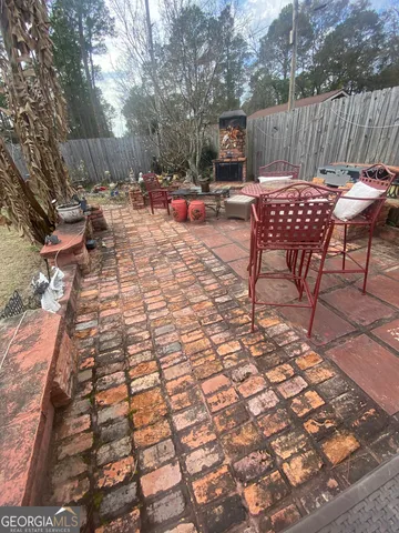 a outdoor dining space with furniture and rug