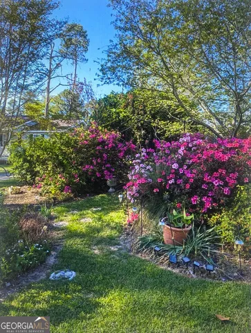 a view of a chairs and table in backyard