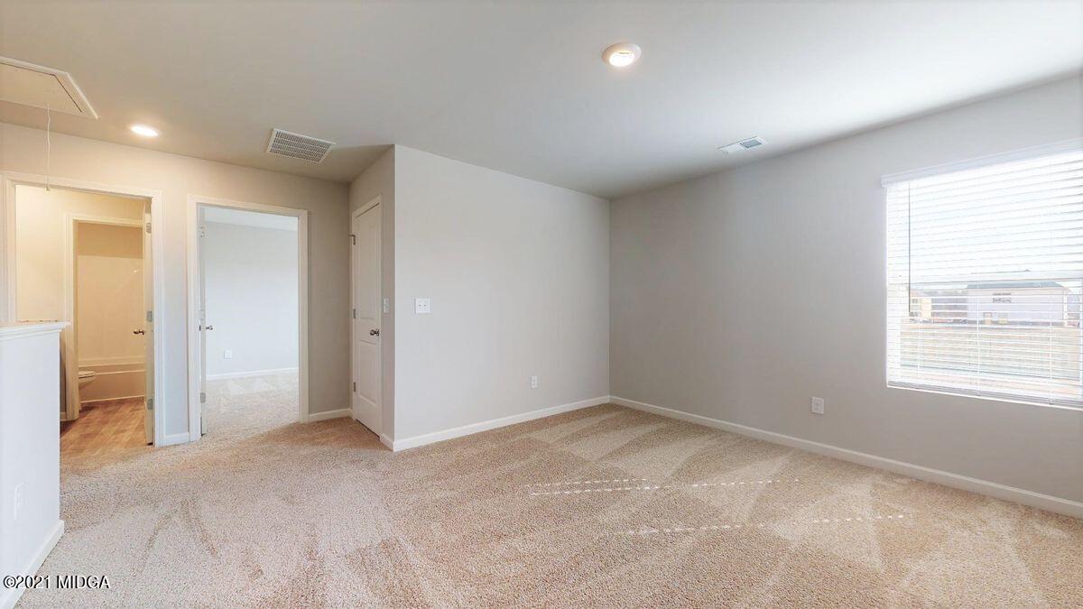 144 Sanders Road, Unit 36 Macon, GA 31210 - Photo 12 of 21 a view of an empty room with a window