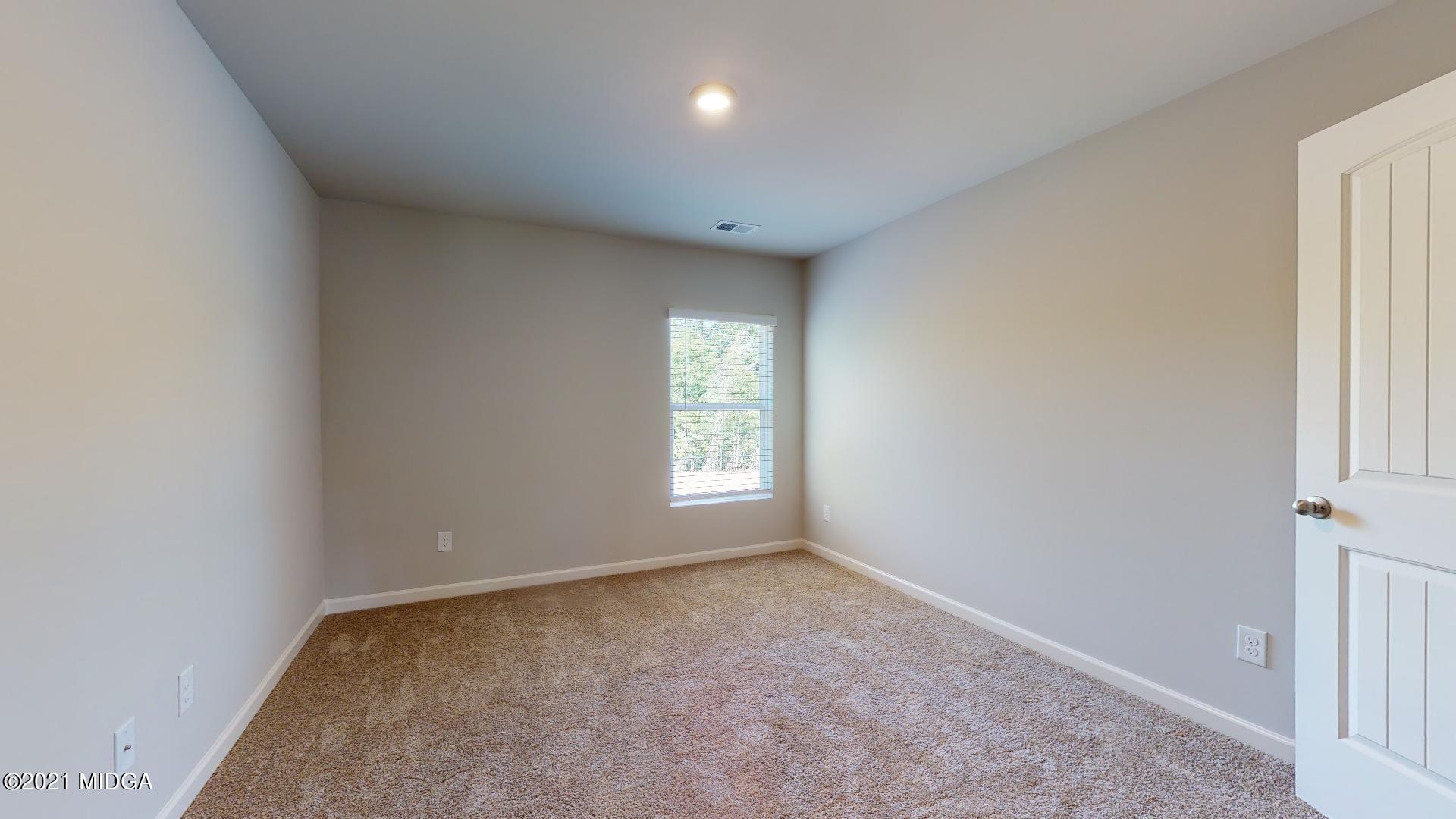 144 Sanders Road, Unit 36 Macon, GA 31210 - Photo 17 of 21 a view of an empty room with a window