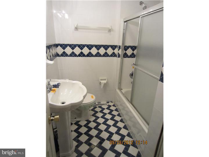 18 Randolph Road Woodbury, NJ 08096 - Photo 12 of 22 a bathroom with a glass shower door