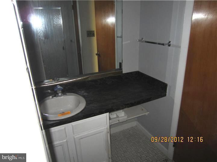 18 Randolph Road Woodbury, NJ 08096 - Photo 16 of 22 a bathroom with a sink and a mirror