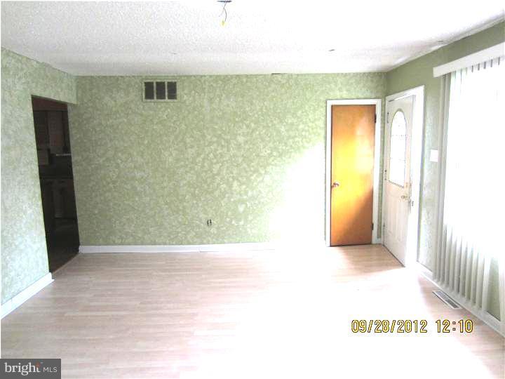 18 Randolph Road Woodbury, NJ 08096 - Photo 3 of 22 a view of an empty room with wooden floor