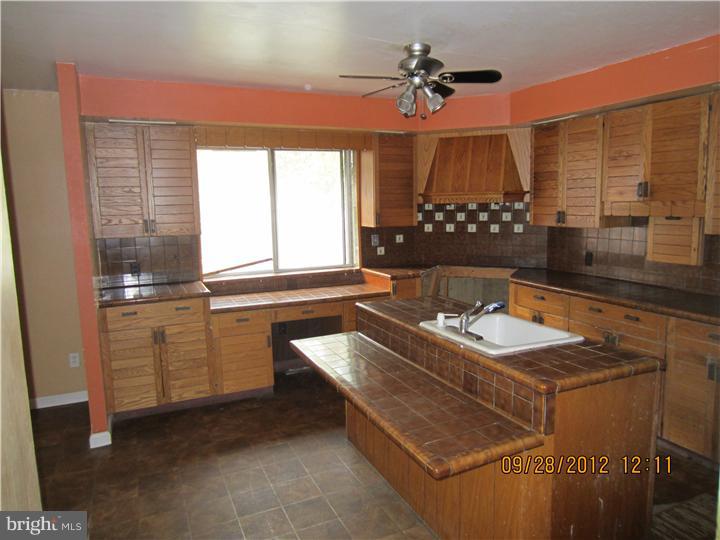 18 Randolph Road Woodbury, NJ 08096 - Photo 6 of 22 a kitchen with sink refrigerator and window