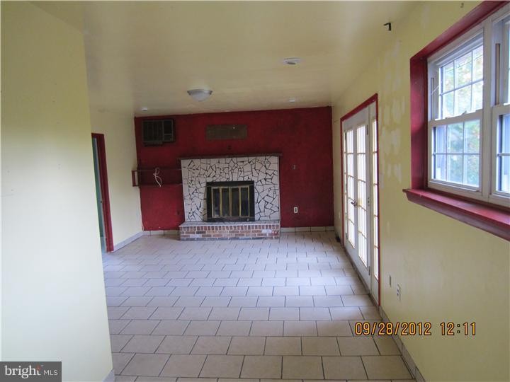 18 Randolph Road Woodbury, NJ 08096 - Photo 9 of 22 a view of an empty room with window and fire place