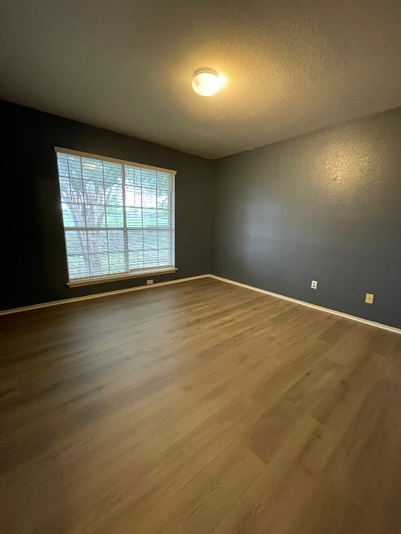 1212 Knoll Ridge Drive Cedar Park, TX 78613 - Photo 6 of 10 Spare room featuring wood finished floors and a textured ceiling