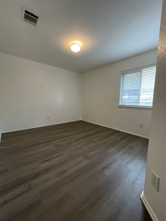 1212 Knoll Ridge Drive Cedar Park, TX 78613 - Photo 7 of 10 Unfurnished room with dark wood-type flooring and baseboards