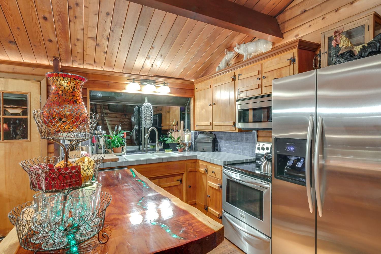 7333 Surette Lane Loomis, CA 95650 - Photo 8 of 42 a kitchen with stainless steel appliances kitchen island granite countertop a refrigerator and a stove