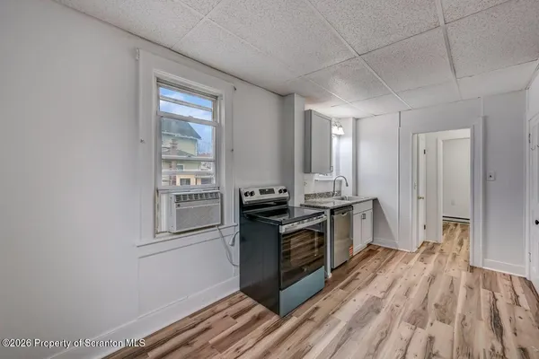a kitchen with stainless steel appliances granite countertop a stove and a refrigerator