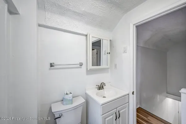 a bathroom with a sink toilet and vanity