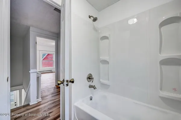 a bathroom with a bathtub and a shower