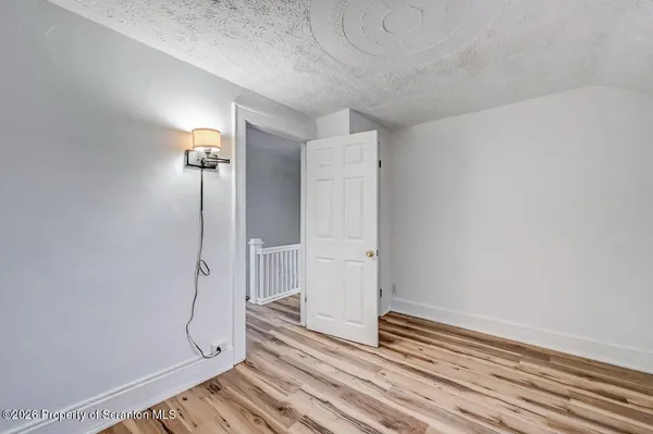 a view of room with window and hardwood floor